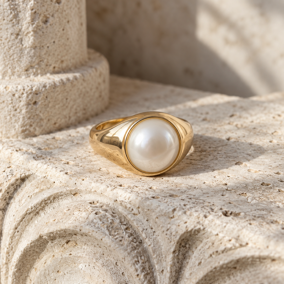 Linden Pearl Signet Ring on carved limestone