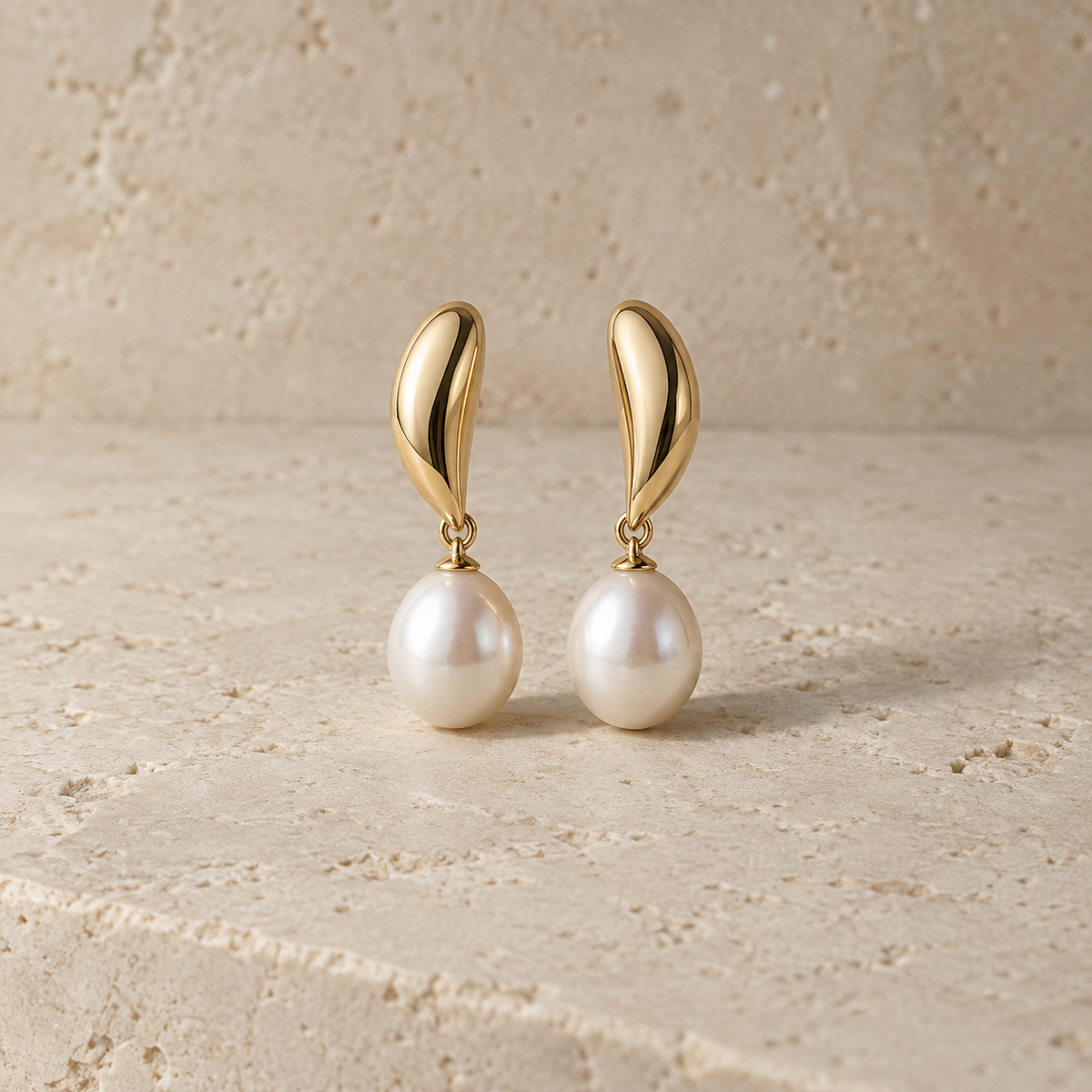 Nocturne Pearl Drop Earrings on warm limestone
